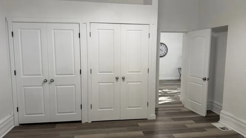 Clean white walls with wood-finish flooring