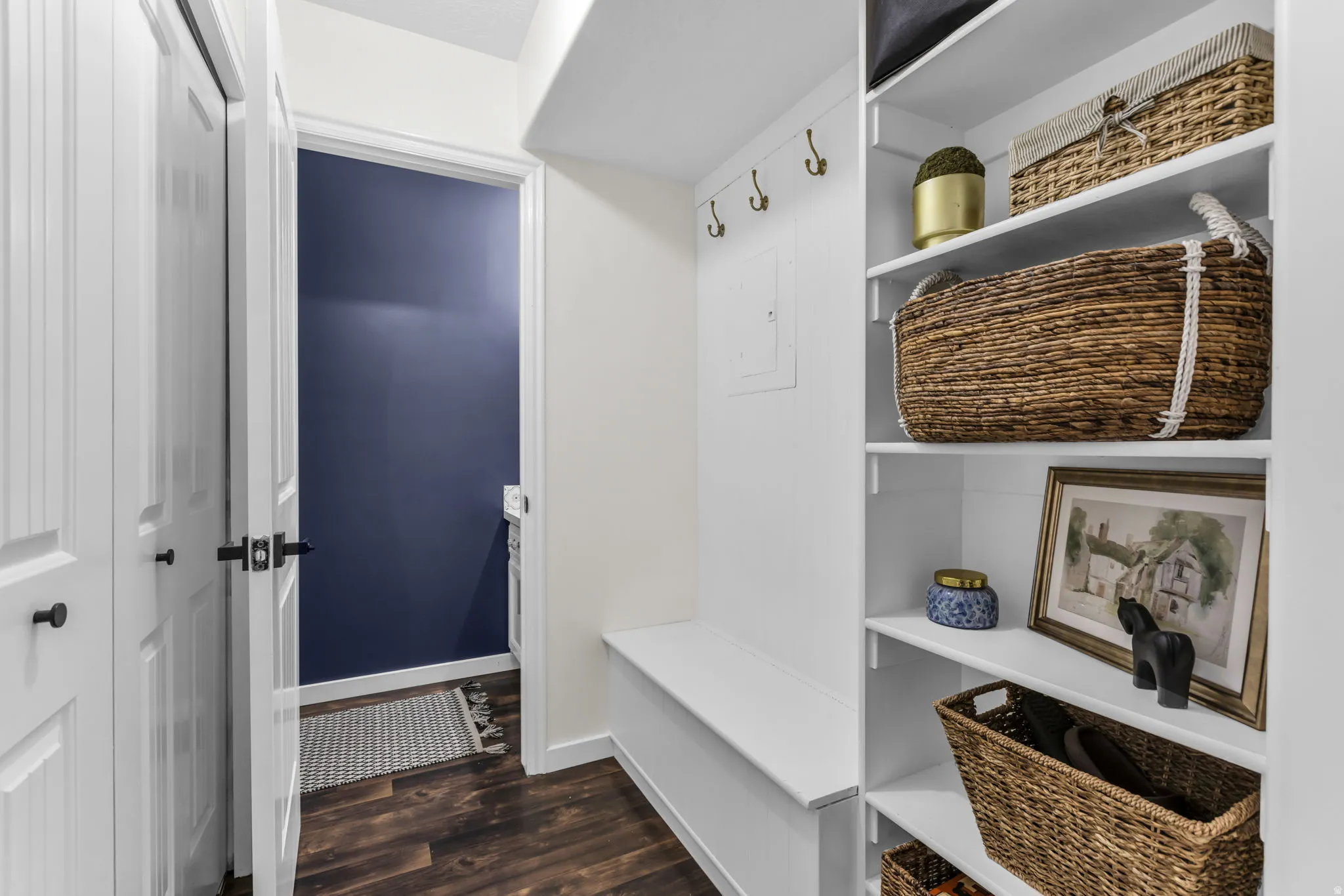 Built-in storage bench, integrated wall hooks, extensive shelving with half bath