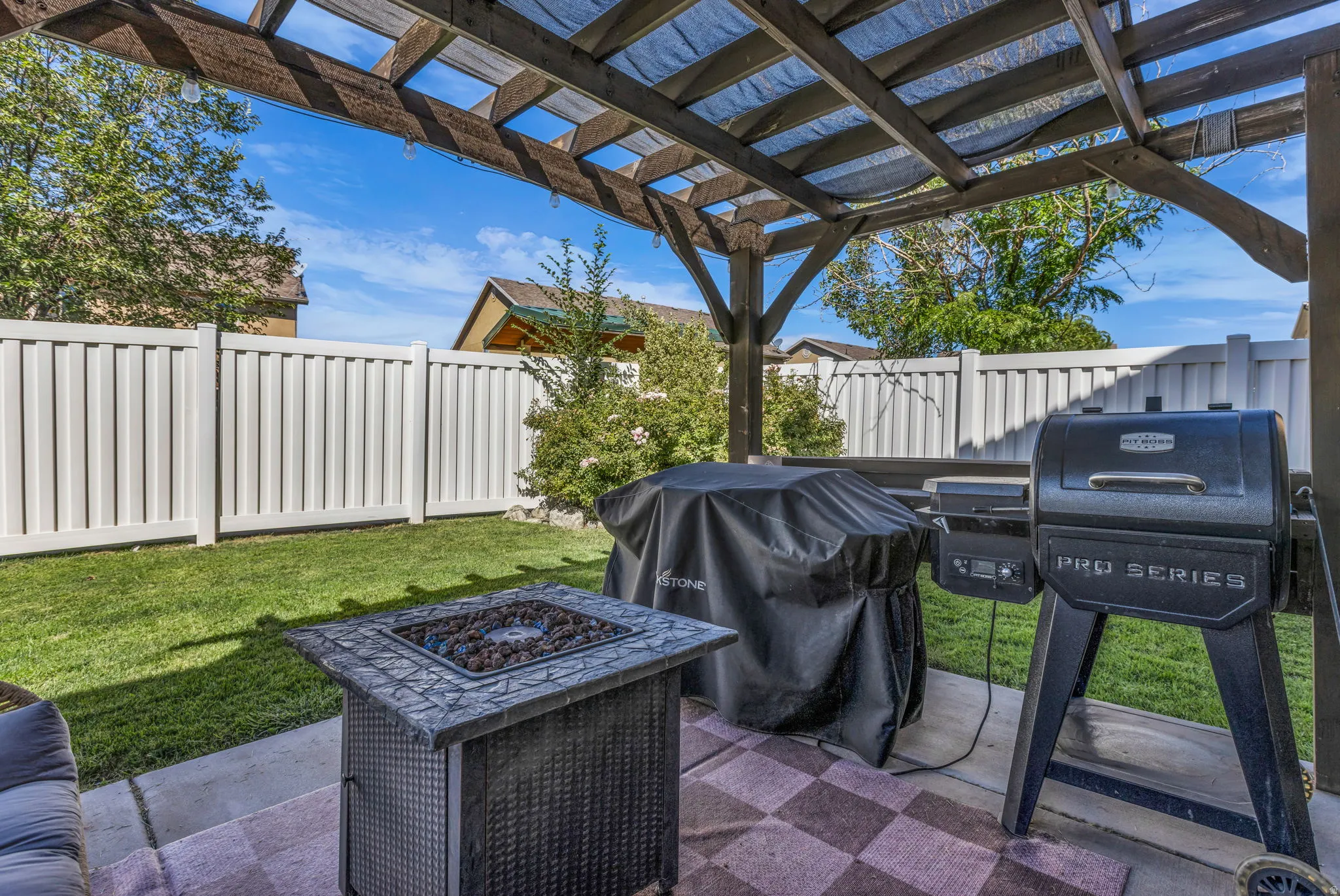 Covered patio with pergola and fully fenced yard