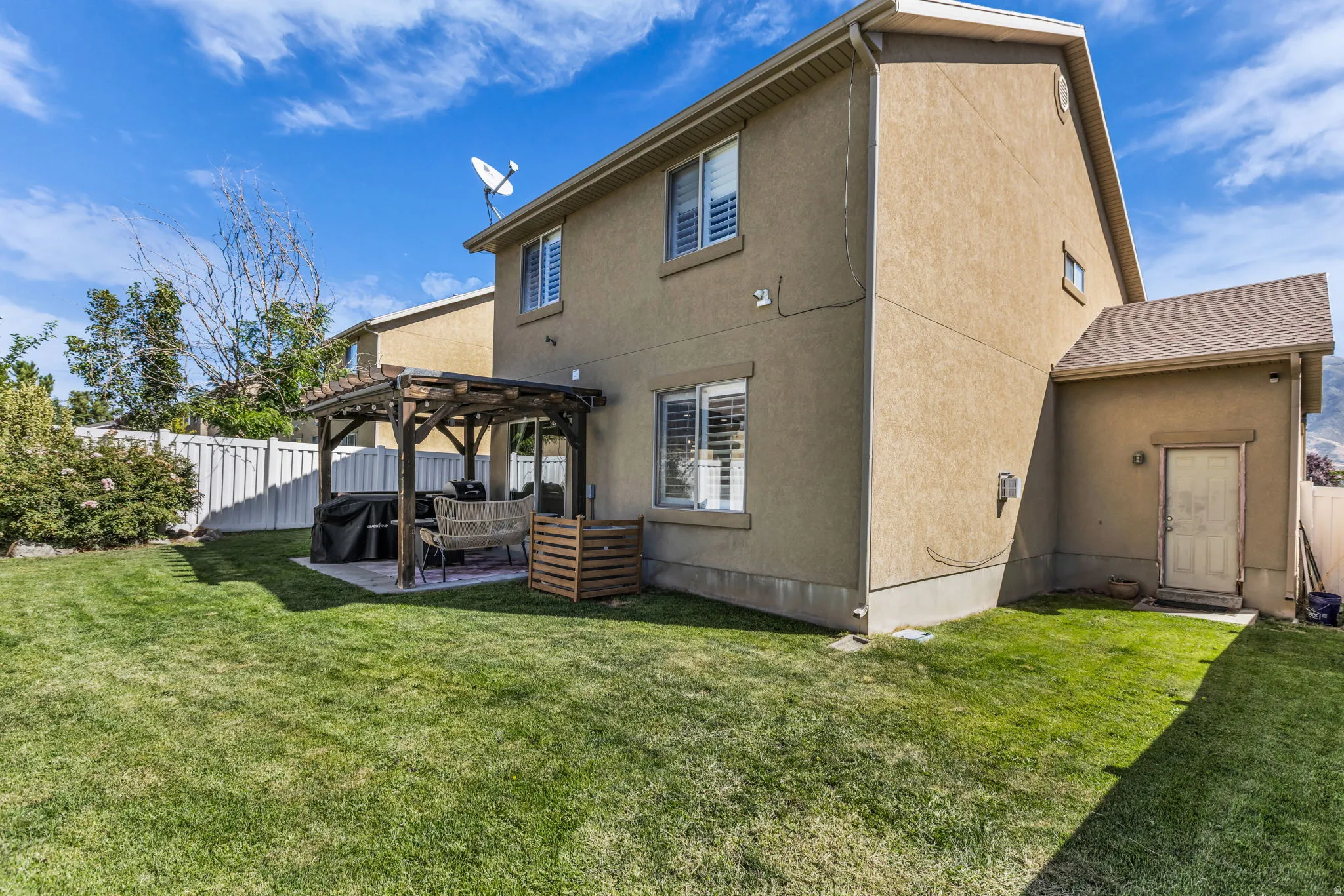 Covered patio with pergola and fully fenced yard
