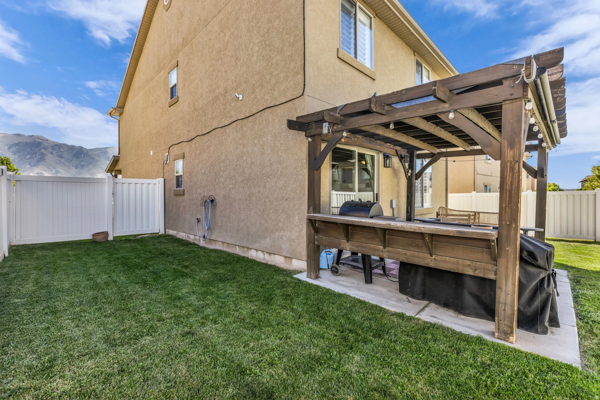 Covered patio with pergola and fully fenced yard