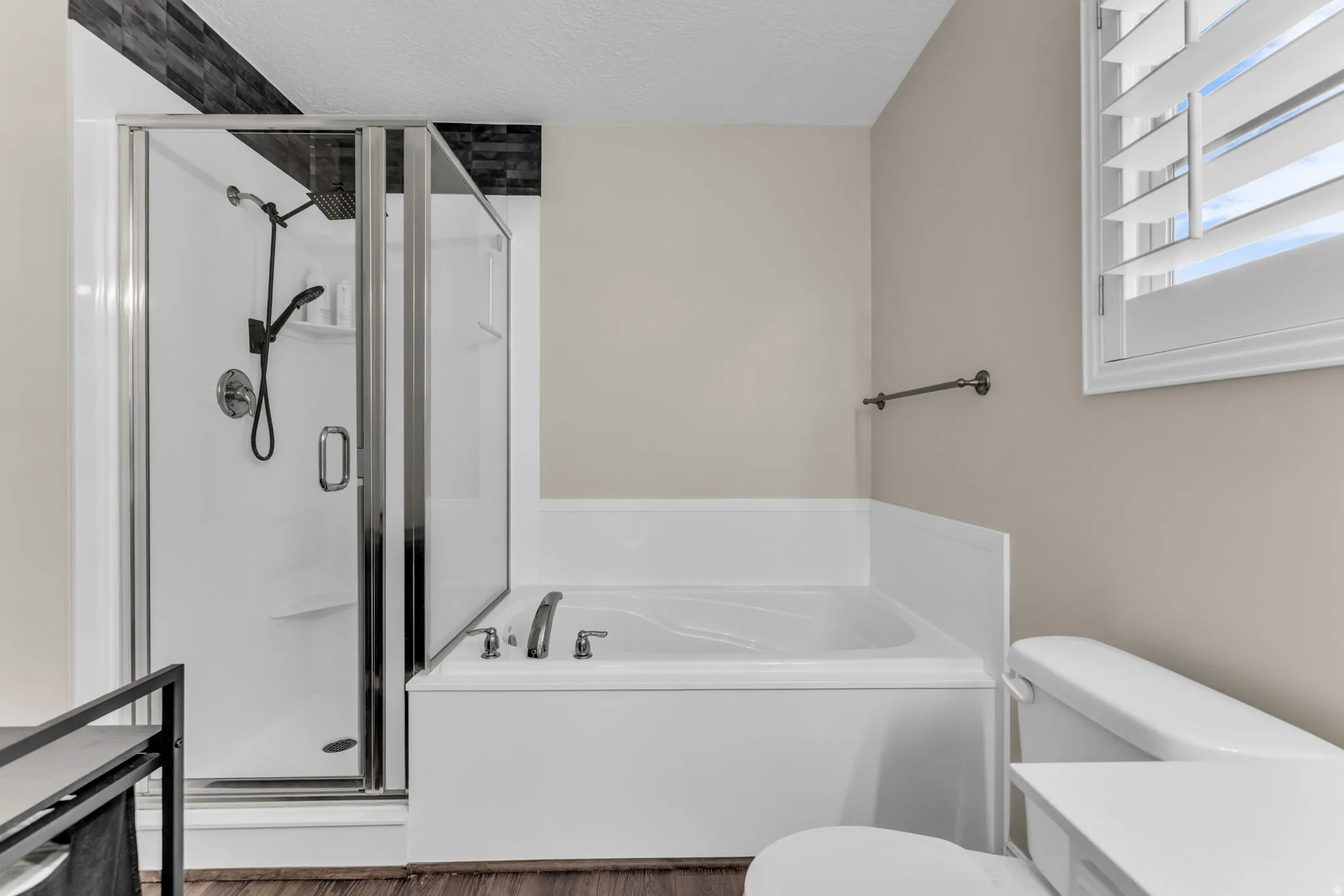 Master bathroom with dual vanity, separate tub and shower, walk in closet