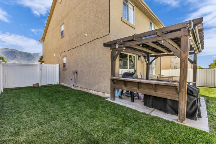 Covered patio with pergola and fully fenced yard