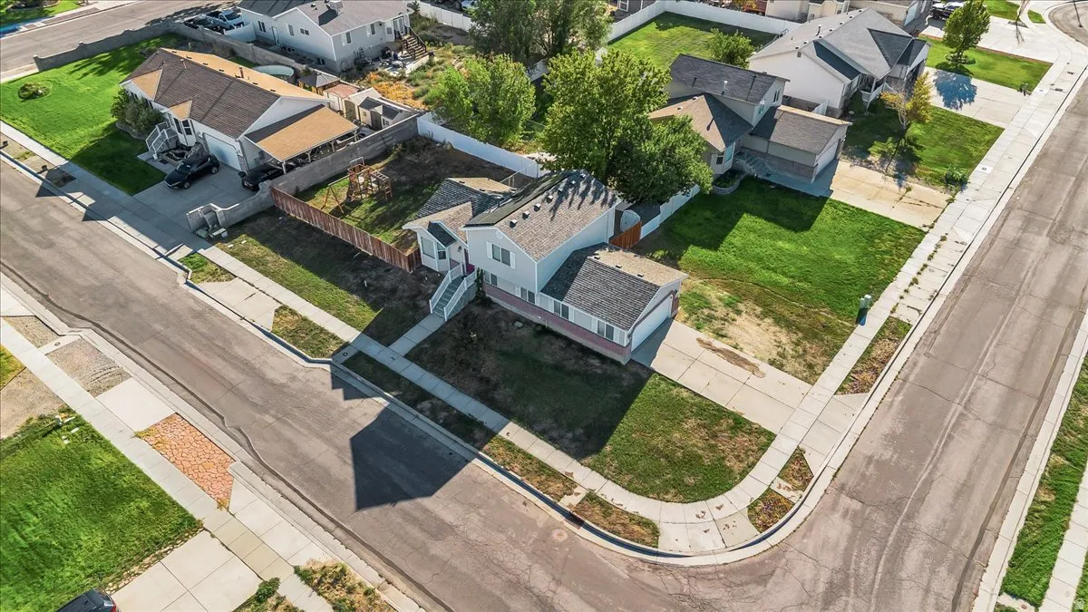 Corner lot with a two-story residence, attached garage, and surrounding green space