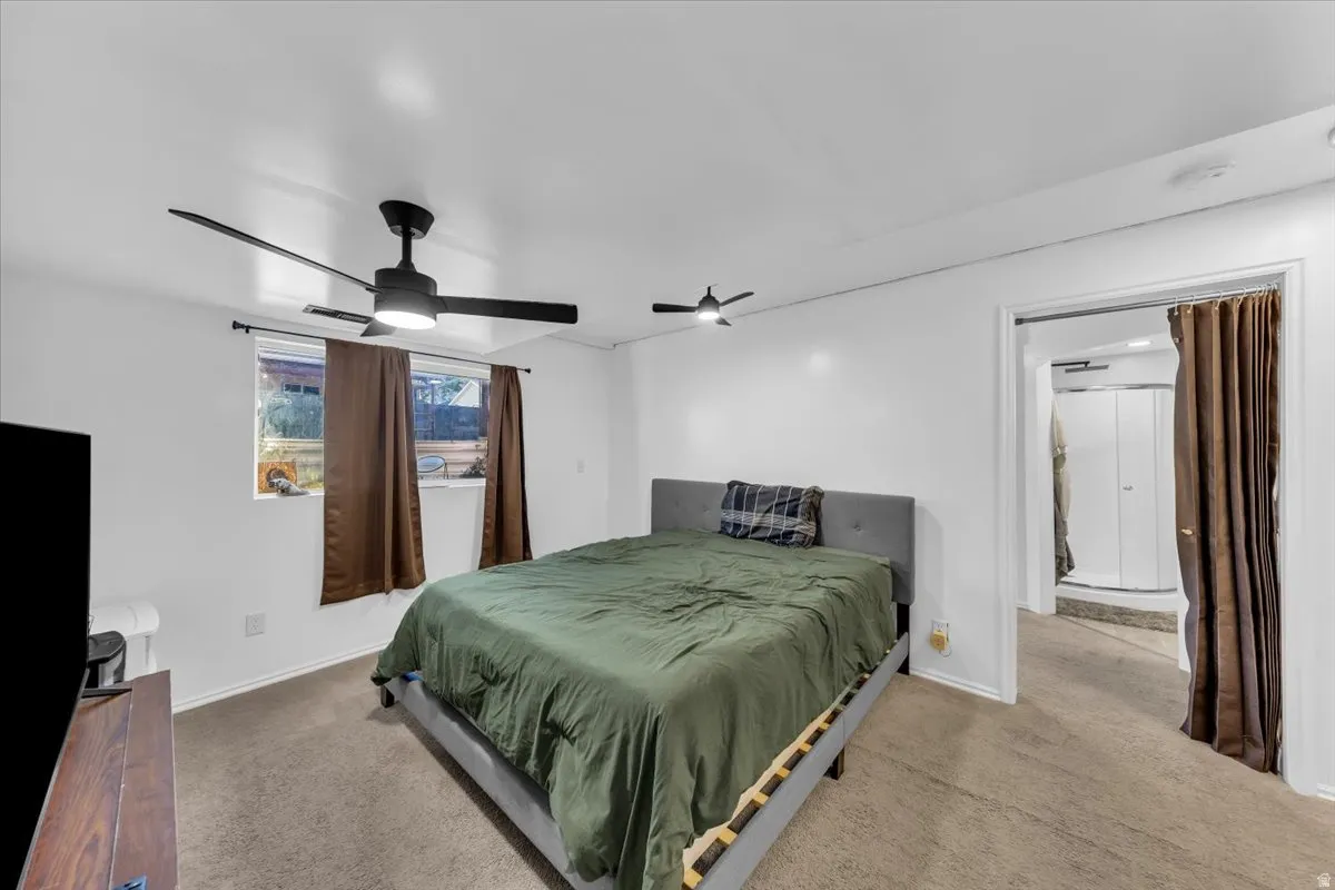 Carpeted room with recessed lighting and two ceiling fans