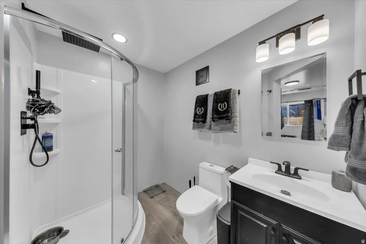 White vanity with black cabinetry, a white rectangular sink, and dark bronze-finish hardware