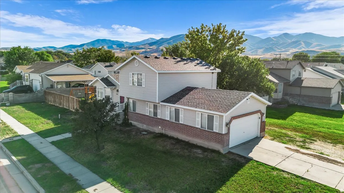 Two-story residence with a brick and siding exterior, attached garage, and a concrete driveway