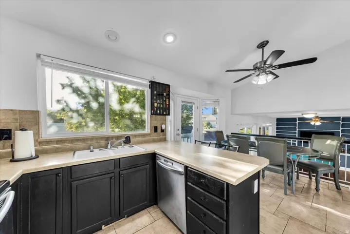 Kitchen featuring dark cabinetry, light countertops, and stainless steel appliances