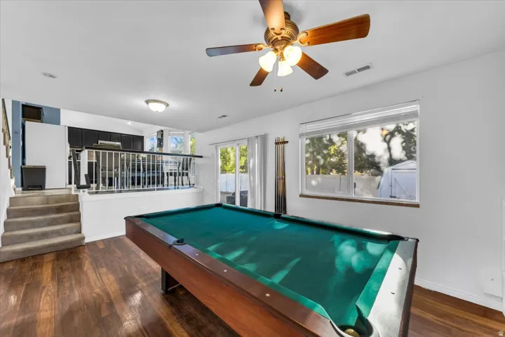 Wood-finish flooring, recessed lighting, and a ceiling fan with integrated lighting