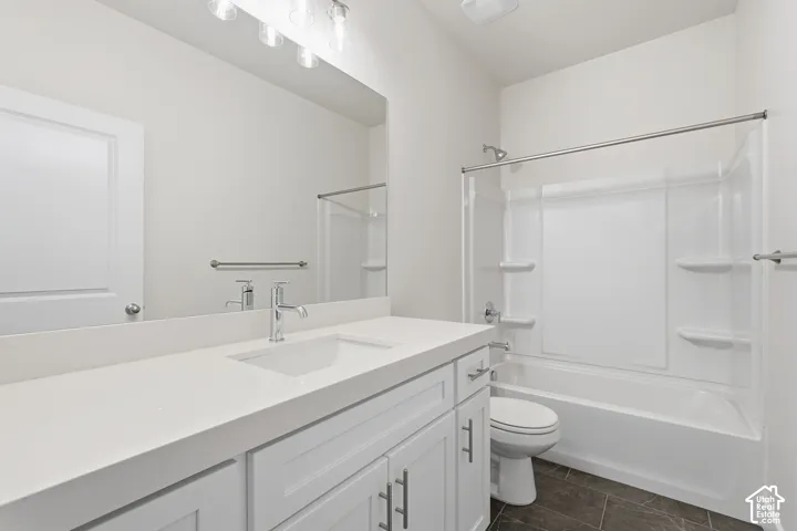 Double vanity with integrated sinks, white cabinetry, chrome fixtures, and a shower-over-tub combination with a white surround