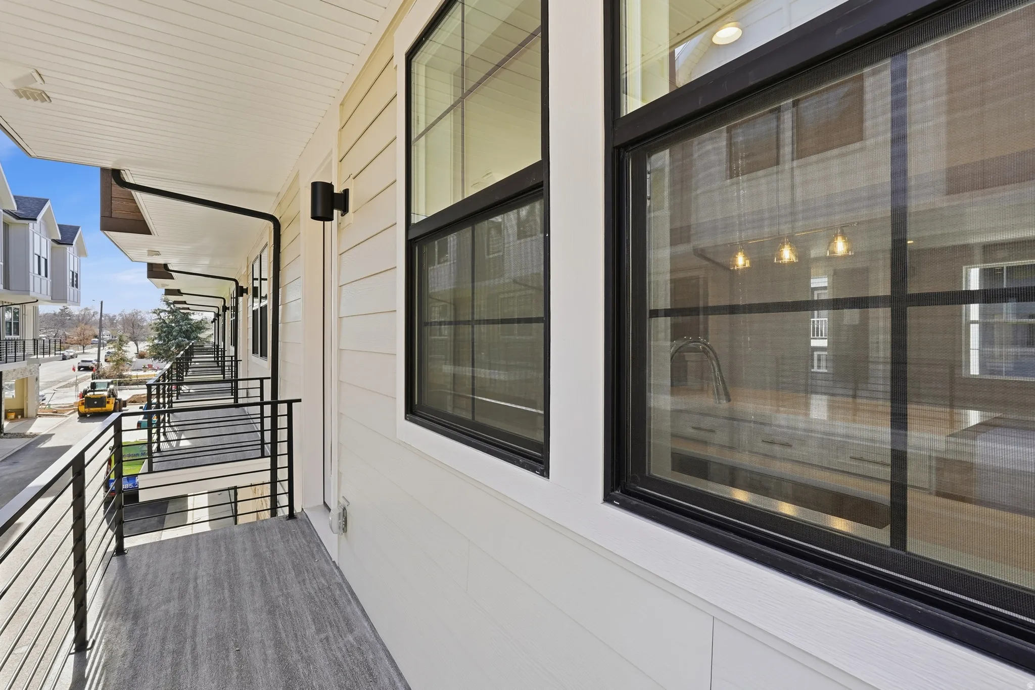Balcony featuring wood-finish flooring and black metal railings