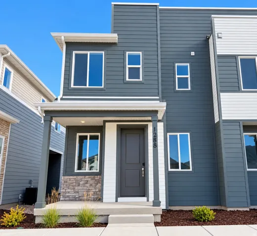 Multi-story exterior with horizontal siding and stone veneer accents