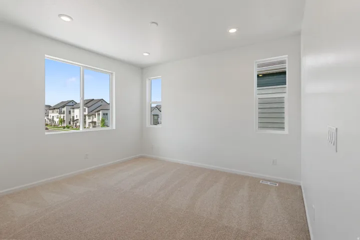 Wall-to-wall carpeting and multiple windows for abundant natural light