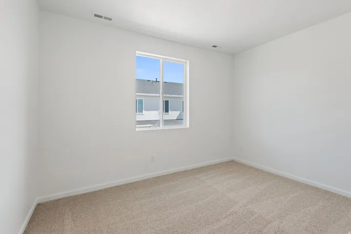 Recessed window with white framing, light-toned carpeting, and neutral wall paint