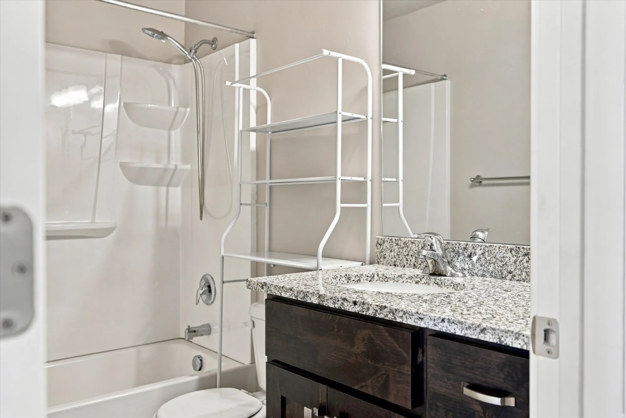 White shower/tub combination with a wall-mounted showerhead