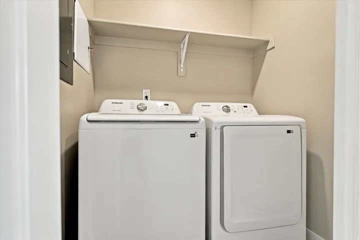 Utility area featuring a mounted storage shelf