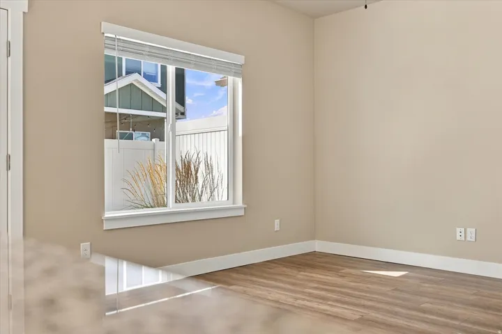 Wood-finish flooring with neutral wall paint and white trim
