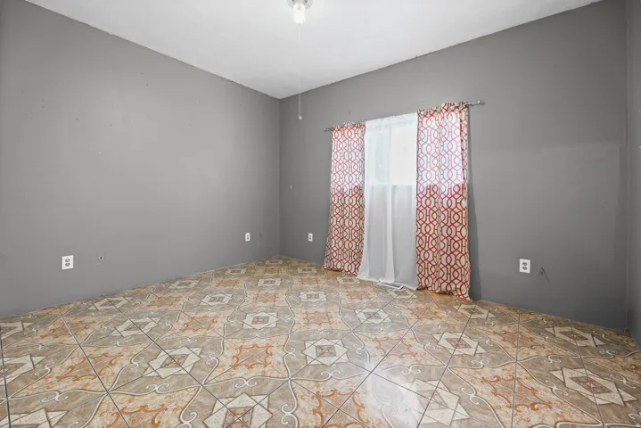 Patterned tile flooring and neutral gray walls