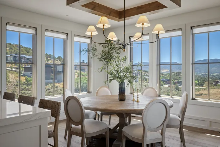 Dining area with wood-finish flooring and a coffered ceiling with wood accents