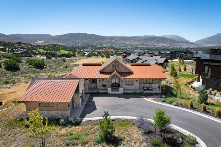 Stone and wood-sided exterior with a metal roof