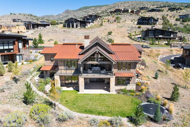 Multi-level structure with a metal roof and stone accents