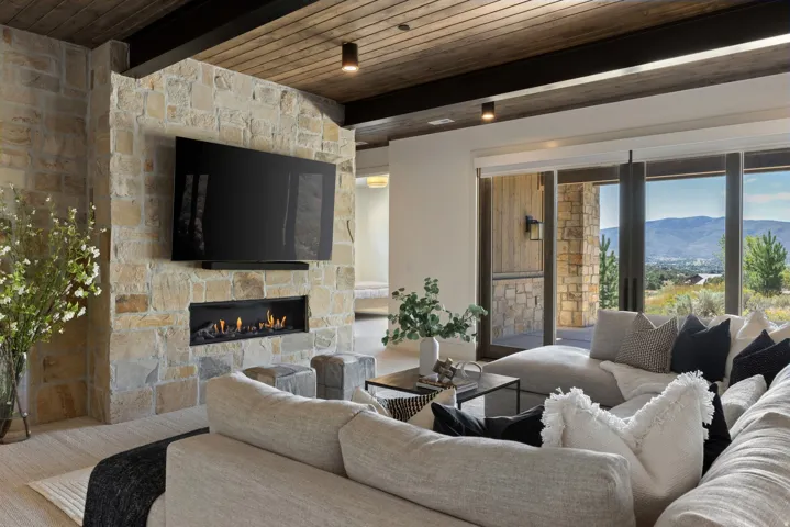 Stone accent wall with built-in linear fireplace