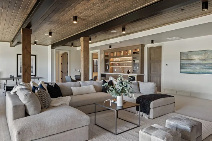 Wood-paneled ceiling with exposed beams and recessed lighting