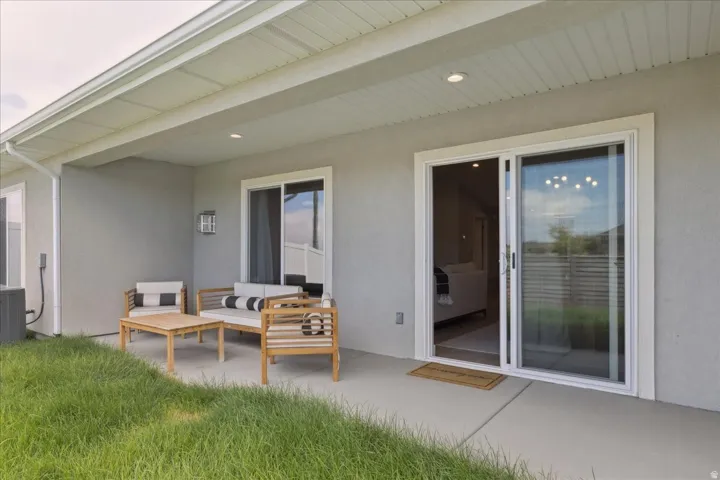 Covered patio with recessed lighting, concrete flooring, and sliding glass door access