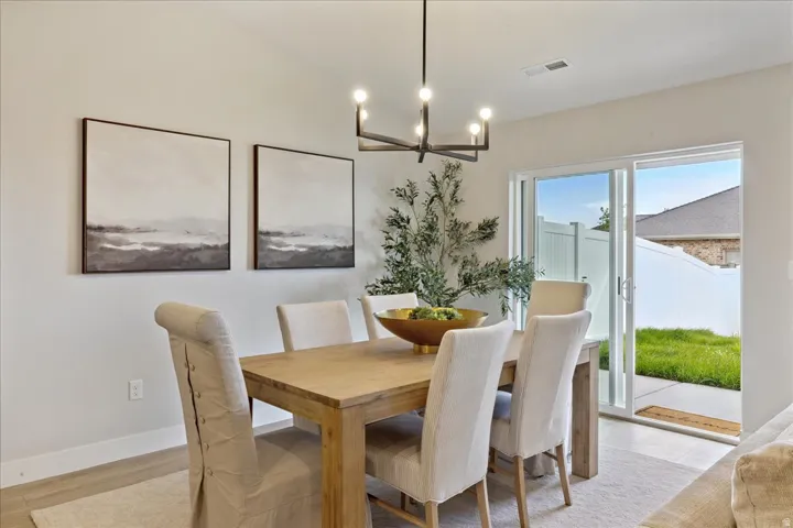 Recessed lighting and a modern chandelier illuminate the space