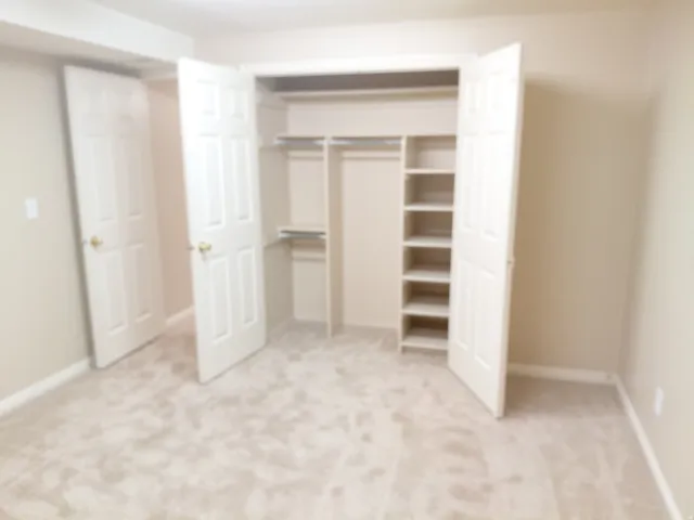 Closet featuring integrated shelving and hanging rods