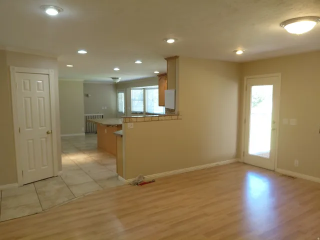 Wood-finish flooring, recessed lighting, and a glass-paneled exterior door