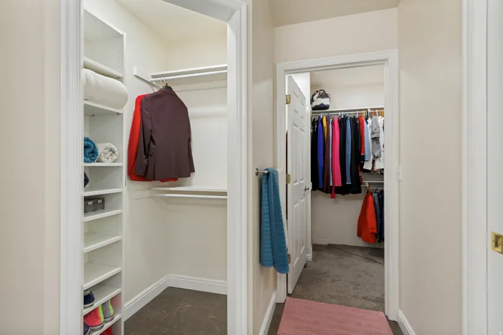 Built-in shelving and hanging rods within a closet space