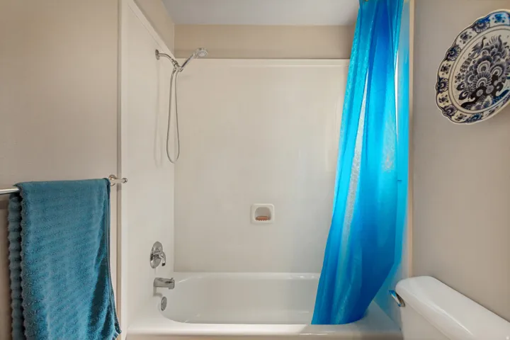 White bathtub with a chrome showerhead and faucet
