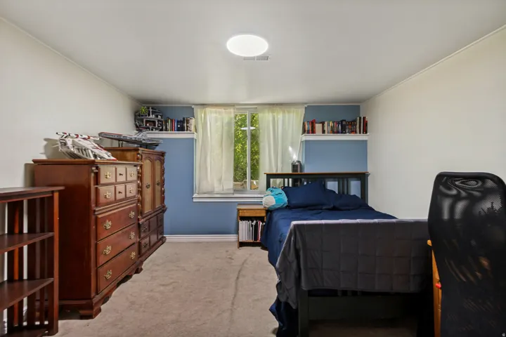 Recessed ceiling light, built-in wall shelving, and a window with exterior visibility