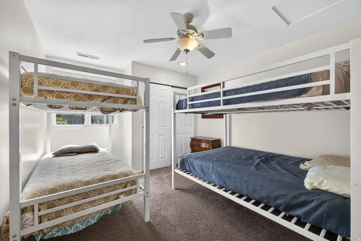 Recessed lighting, ceiling fan with light fixture, window with natural light, wall-to-wall carpeting, and barn-style sliding door