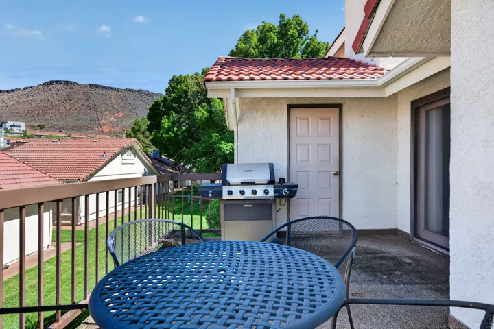 Private balcony featuring iron railing and stucco exterior