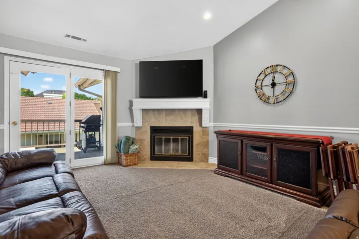 Corner fireplace with a tile surround and a white mantel