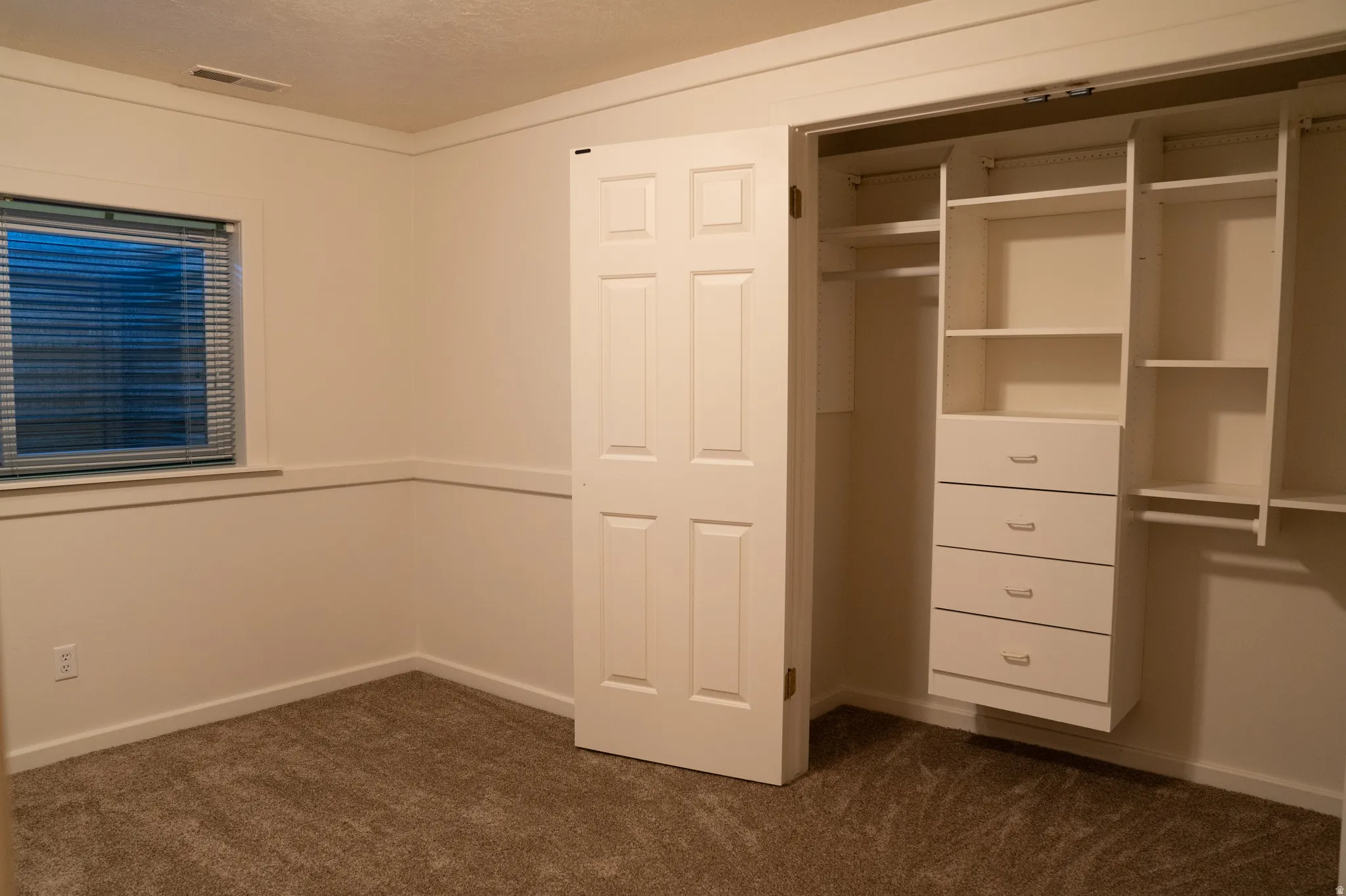 Built-in closet organization system with shelving and drawers