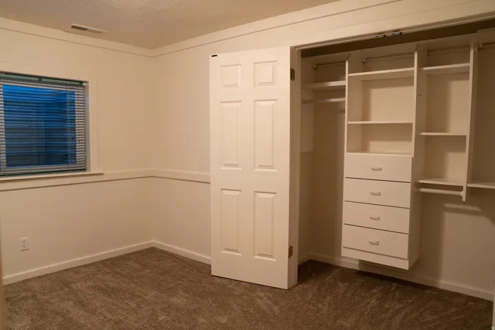 Built-in closet organization system with shelving and drawers