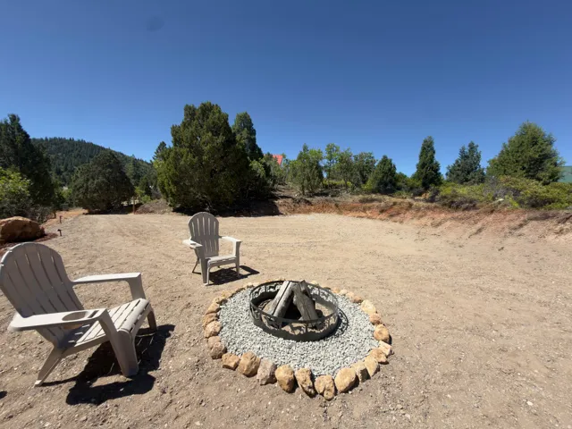 Outdoor space featuring a fire pit with a stone border and gravel inlay