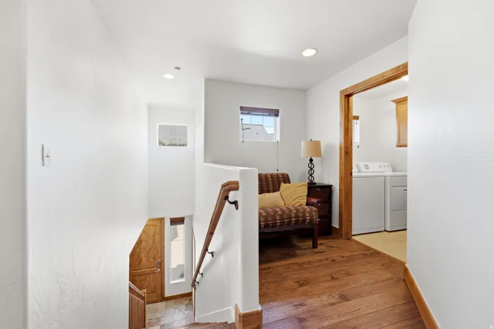 Wood-finish flooring throughout the hallway