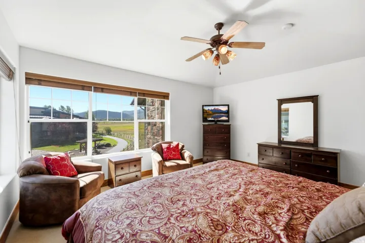 Expansive windows showcasing a distant mountain range and a winding paved path