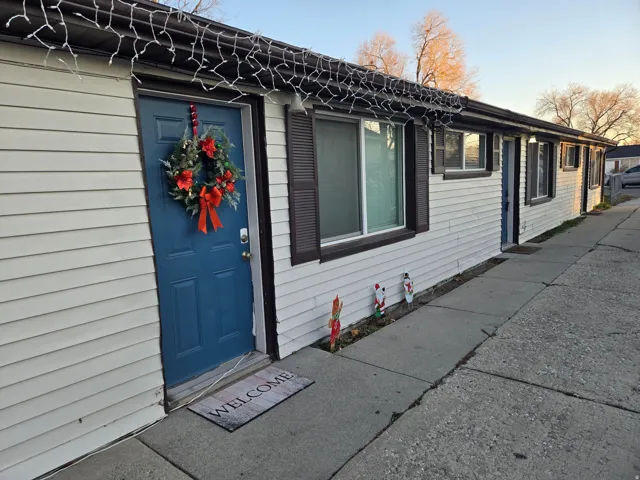 White horizontal siding with a blue entry door