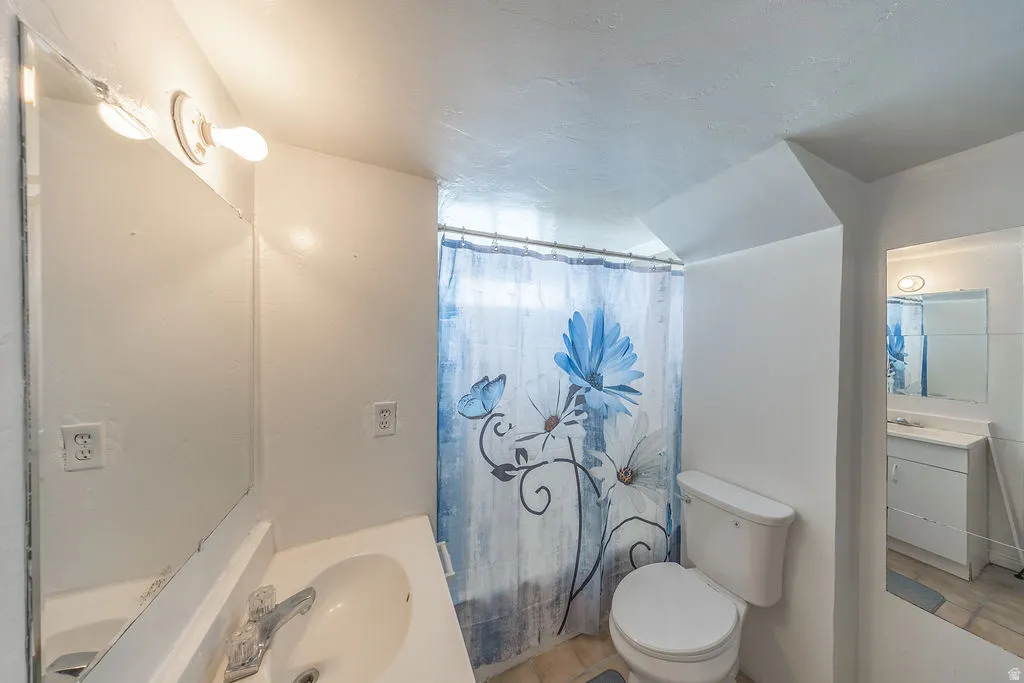 White vanity with an integrated sink and wall-mounted mirror