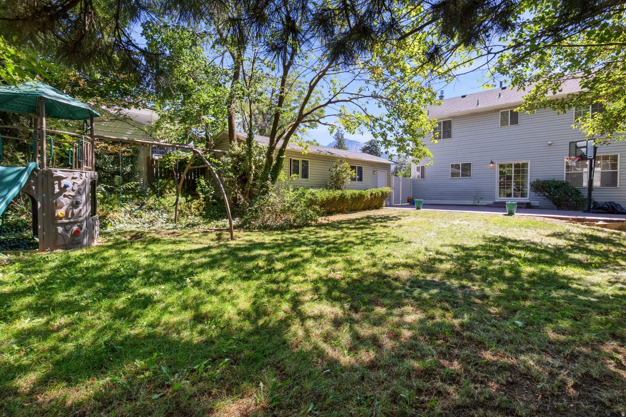 Expansive grassy yard with mature trees