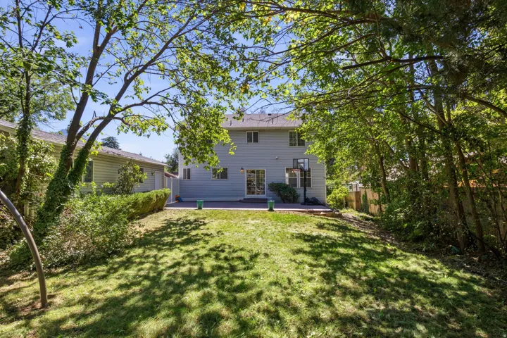 Expansive green lawn with a spacious patio area