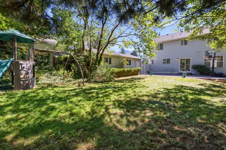 Expansive grassy yard with mature trees