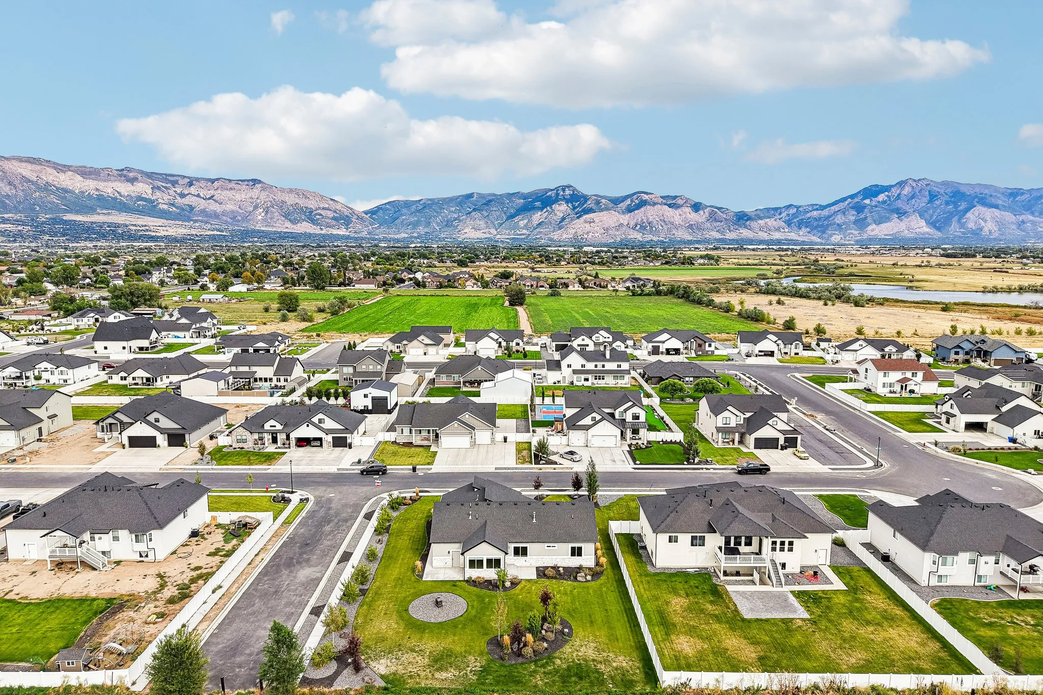 Expansive neighborhood featuring residential homes, manicured lawns, and paved streets