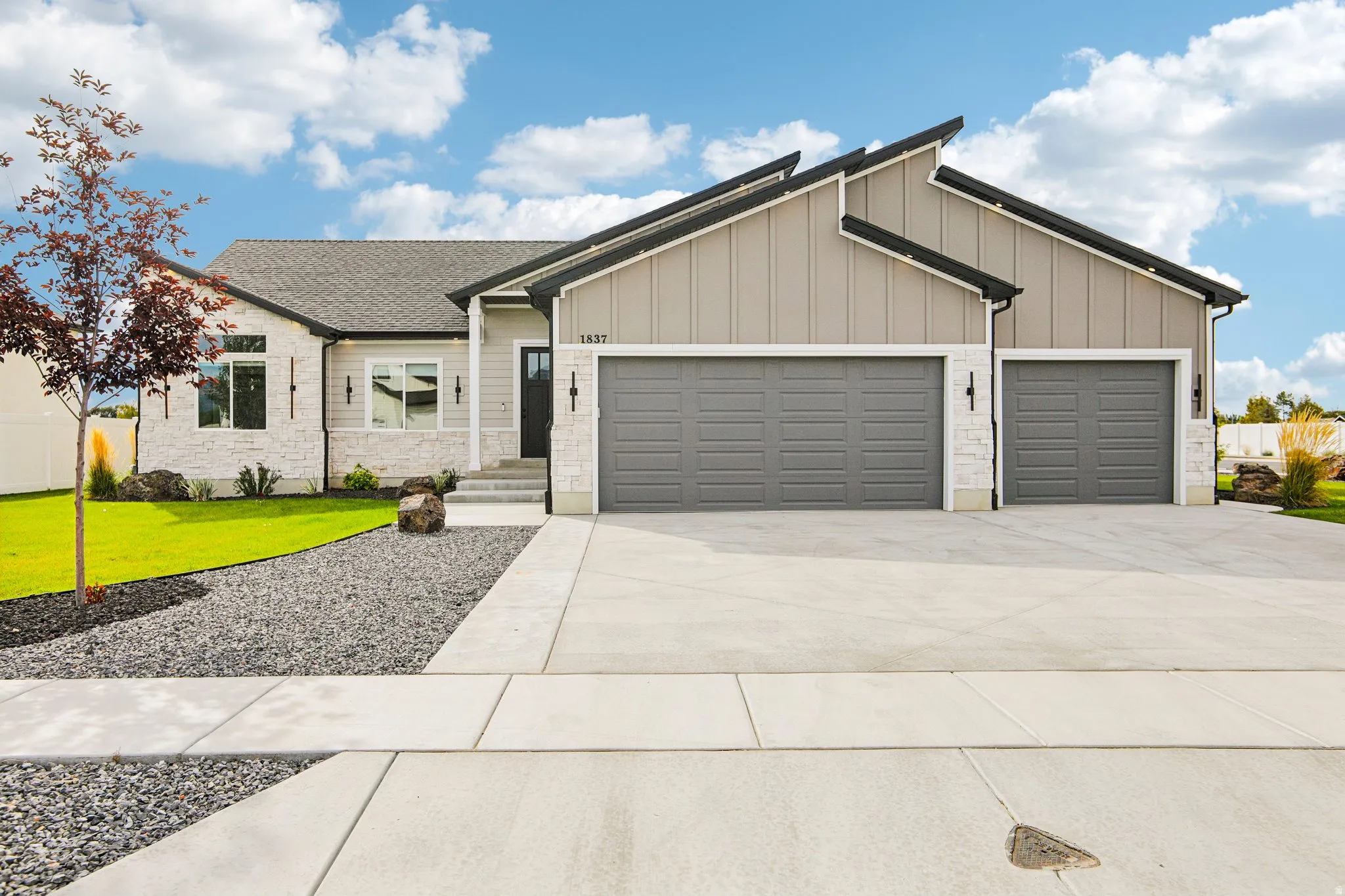 Contemporary exterior with a multi-textured facade including board and batten and stone accents