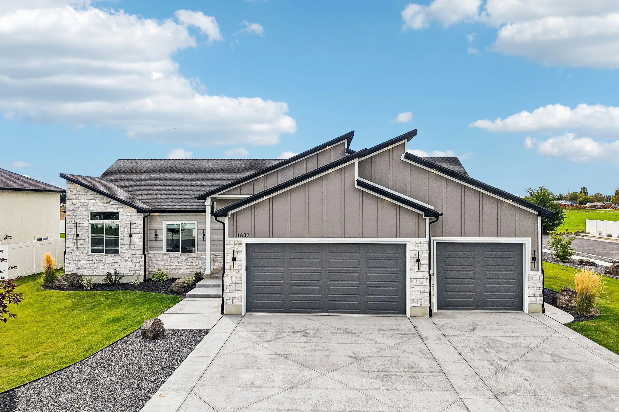 Contemporary exterior with stone veneer and vertical siding accents